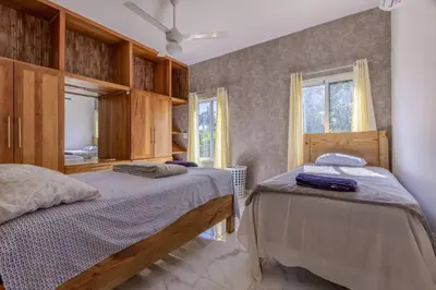 a bedroom with two beds and a mirror at Luxurious Home with Pool in San Felipe de Puerto Plata