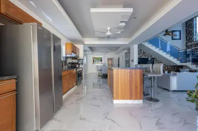 a kitchen with a counter and a dining room at Luxurious Home with Pool in San Felipe de Puerto Plata