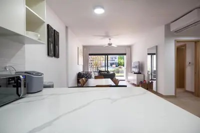 a white room with a kitchen and a living room at Bran new condo with pool access in Punta Cana