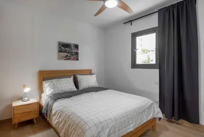 a bedroom with a bed and a ceiling fan at Bran new condo with pool access in Punta Cana