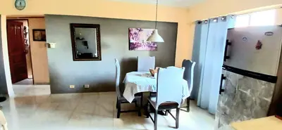 a dining room with a table with chairs and a mirror at Sol Mar Alegre II in Boca Chica