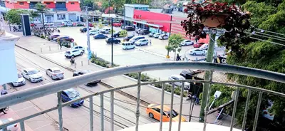a view of a busy city street with cars parked at Sol Mar Alegre II in Boca Chica