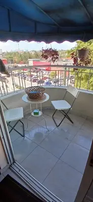 a balcony with a table and two chairs on a patio at Sol Mar Alegre II in Boca Chica