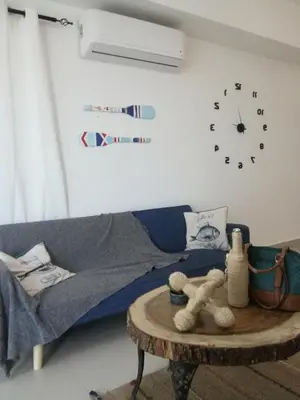 a living room with a couch and a table with a teddy bear at Vista al mar in Boca Chica