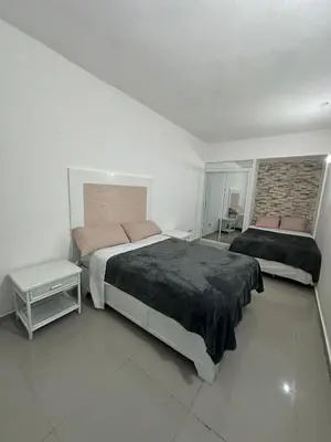 a bedroom with a large bed and a window at Apartahotel-E vista catalina in La Romana