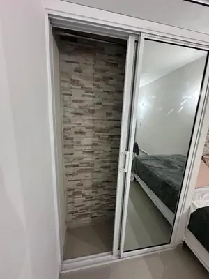 a sliding glass door in a bedroom with a brick wall at Apartahotel-E vista catalina in La Romana