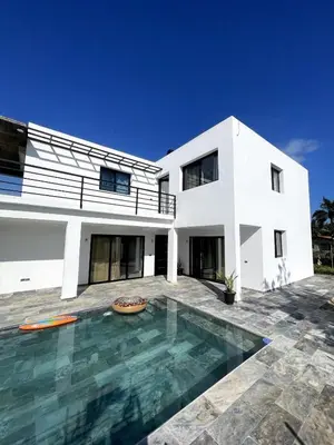 a white house with a swimming pool in front of it at Apartamento Entre Playas 1 - 3 pax, 4 min de la playa in Las Galeras