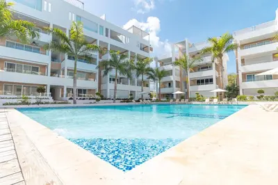 a swimming pool in front of a apartment building at Beautiful Apartment 10 min from Bayahibe beach Las Terrazas in Bayahibe