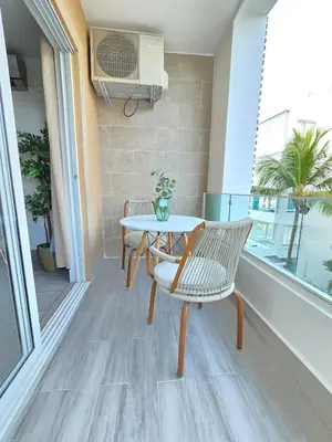 a balcony with a table and chairs and a window at Beautiful Apartment 10 min from Bayahibe beach Las Terrazas in Bayahibe