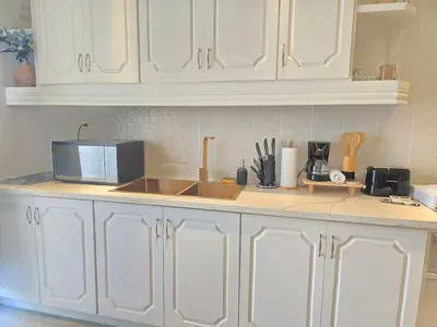 a kitchen with white cabinets and a counter top at Beautiful Apartment 10 min from Bayahibe beach Las Terrazas in Bayahibe