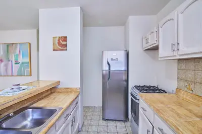 a kitchen with a stainless steel refrigerator and a sink at A Beautiful Studio Apartments Furnished in Gascue in Santo Domingo