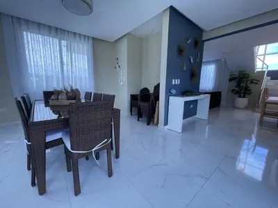 a dining room and living room with a table and chairs at Villa VP One - Punta rucia beach in Punta Rucia