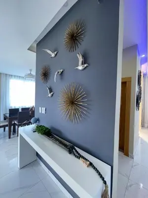 a blue wall with birds and mirrors on it at Villa VP One - Punta rucia beach in Punta Rucia