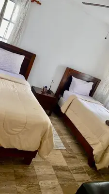 two beds sitting next to each other in a bedroom at Un Lugar Único y Céntrico RD Los Corales in Punta Cana