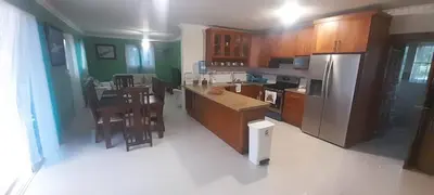 a kitchen with wooden cabinets and a stainless steel refrigerator at Luxury in Cabarete