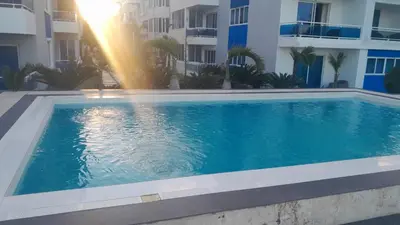 a swimming pool in front of a building at Luxury in Cabarete