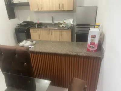 a kitchen with a counter with a sink and a stove at Antare ll edificio 52 A3 in Santo Domingo
