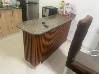 a kitchen with a wooden island in the middle at Antare ll edificio 52 A3 in Santo Domingo