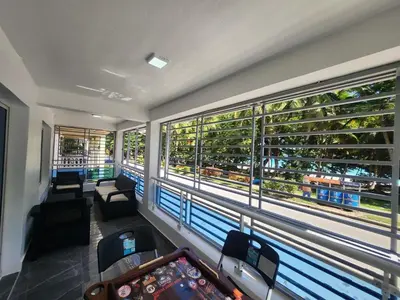 a room with a balcony with a view of the city at Apartment in front of beach, AC, Wifi, Hot Water in Paraíso