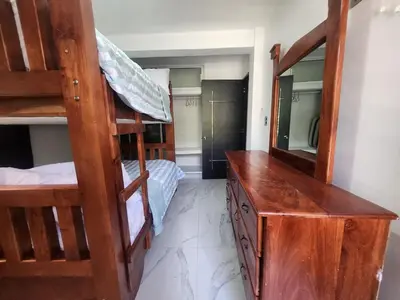 a bedroom with two bunk beds and a mirror at Apartment in front of beach, AC, Wifi, Hot Water in Paraíso