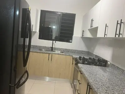 a kitchen with a stove and a window in it at Comfortable apartment in Los Mameyes
