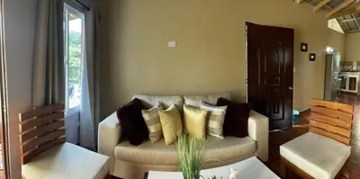 a living room with a couch with pillows on it at Casa lopez in Jarabacoa