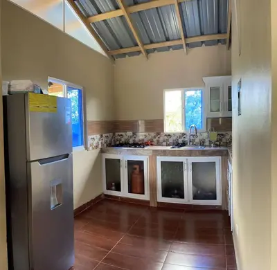 a kitchen with a sink and a refrigerator at Casa lopez in Jarabacoa