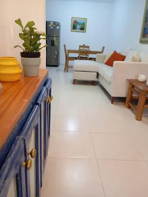 a kitchen and living room with a couch and a table at Ciudad Juan Bosch StoDgo este in La Javilla