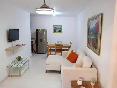 a living room with a couch and a table at Ciudad Juan Bosch StoDgo este in La Javilla