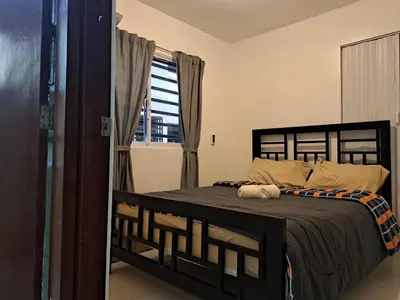 a bedroom with a bed and a window at Ciudad Juan Bosch StoDgo este in La Javilla