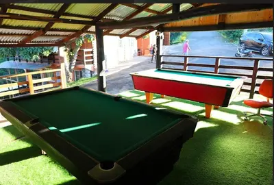a pool table sitting under a pavilion with awning at Vista Montaña Jimenoa de la Rosa in Jarabacoa
