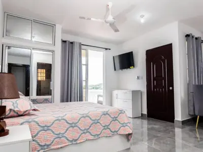 a bedroom with a bed and a ceiling fan at Villas Hillside apt 4 in Santa Bárbara de Samaná