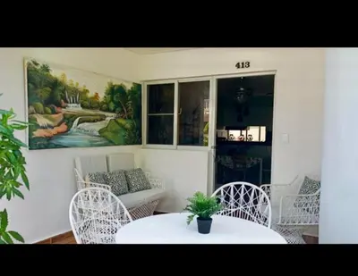 a room with a table and chairs and a couch at Kasita del sol boca chica in Boca Chica