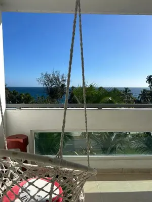 a swing in a room with a view of the ocean at Vista al Caribe in La Francia