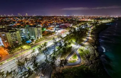 a city at night with the ocean and a road at Vista al Caribe in La Francia