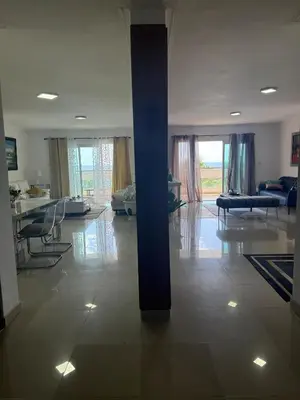 a living room with a pillar in the middle of a room at Vista al Caribe in La Francia