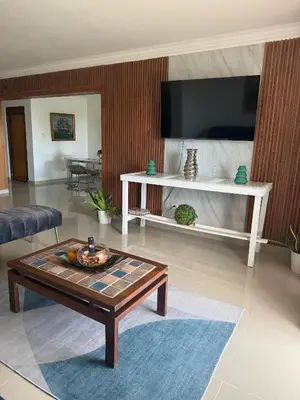 a living room with a tv and a coffee table at Vista al Caribe in La Francia