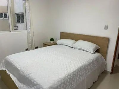 a white bed with two pillows in a bedroom at Vista al Caribe in Los Mameyes