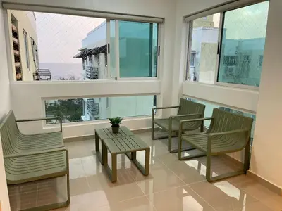 a room with three chairs and a table and windows at Vista al Caribe in Los Mameyes