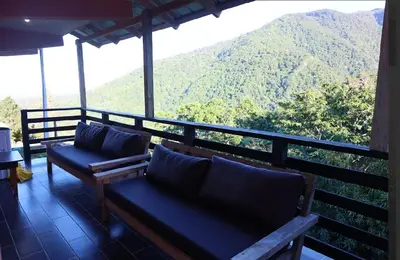 a balcony with benches and a view of a mountain at Vista Montaña Jimenoa De La Rosa in Jarabacoa