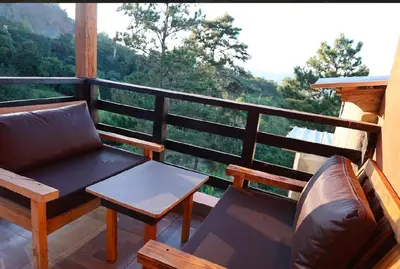 a porch with a couch and a table on a balcony at Vista Montaña Jimenoa De La Rosa in Jarabacoa