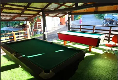 a pool table sitting under a pavilion with a pool table at Vista Montaña Jimenoa De La Rosa in Jarabacoa