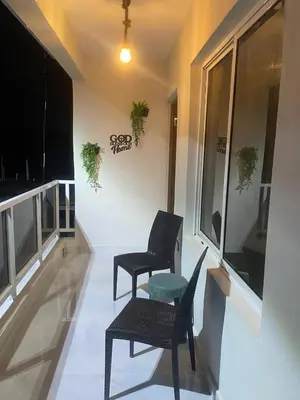a balcony with two chairs and a table and a window at Heaven apart cerca del aeropuerto parqueo incluído TAXI DISPONIBLE in Monte Adentro