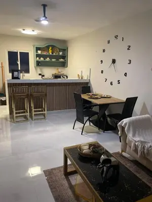 a living room with a large clock on the wall at Heaven apart cerca del aeropuerto parqueo incluído TAXI DISPONIBLE in Monte Adentro