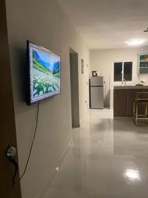 a television hanging on a wall in a living room at Heaven apart cerca del aeropuerto parqueo incluído TAXI DISPONIBLE in Monte Adentro