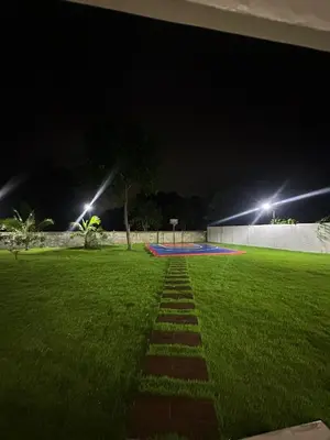 a pathway in a field at night with lights at Villa Canaan in Pedro Brand