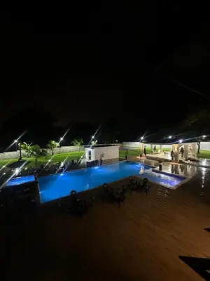 a swimming pool lit up at night at Villa Canaan in Pedro Brand