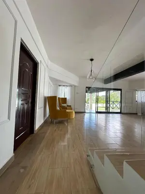 a living room with a yellow chair and a couch at Villa Canaan in Pedro Brand