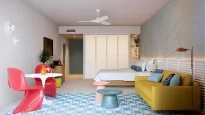 a bedroom with a bed and a couch and a table at Fiesta Americana Funeeq Punta Cana All Inclusive in Punta Cana