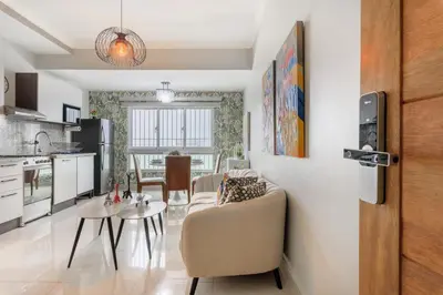 a kitchen and living room with a couch and a table at Charming space in the city center in Santo Domingo